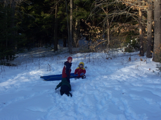 Cousins sledding together